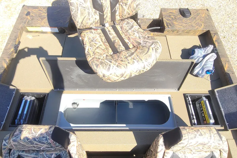 Slide: The Image of 2026 G3 Sportsman 1710 boat interior with camo seats and storage compartments. - 17
