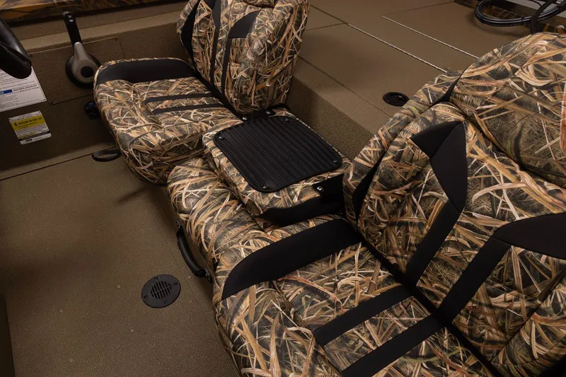 Slide: The Image of 2026 G3 Sportsman 1710 boat interior with camo-patterned seats and storage compartment. - 6