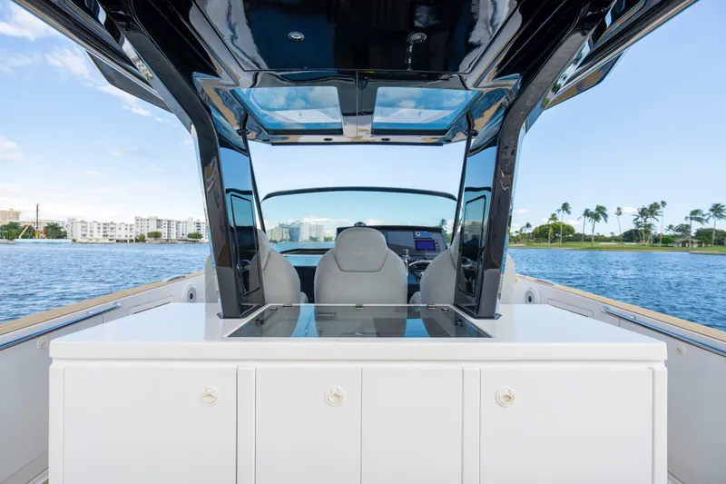 Slide: The Image of 2021 Pardo Yachts 38 cockpit with luxurious seating and modern controls, overlooking serene waters. - 52