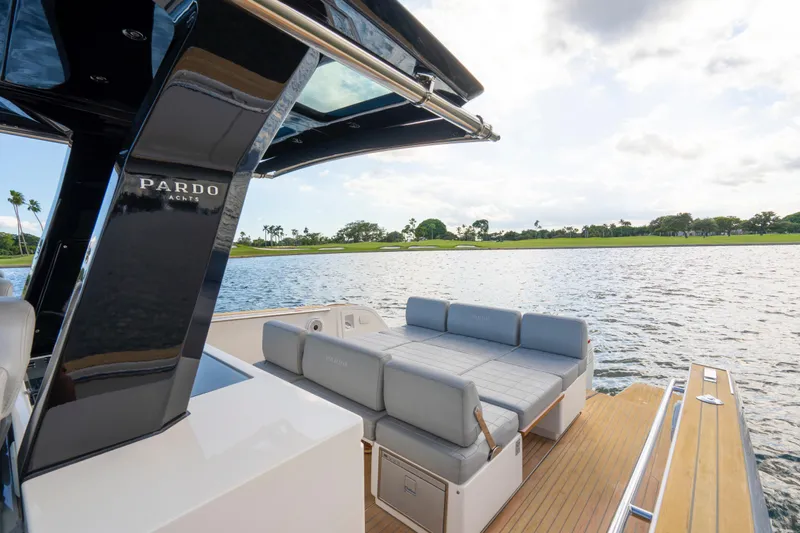 Slide: The Image of 2021 Pardo Yachts 38 with luxurious seating on a serene water backdrop. - 12