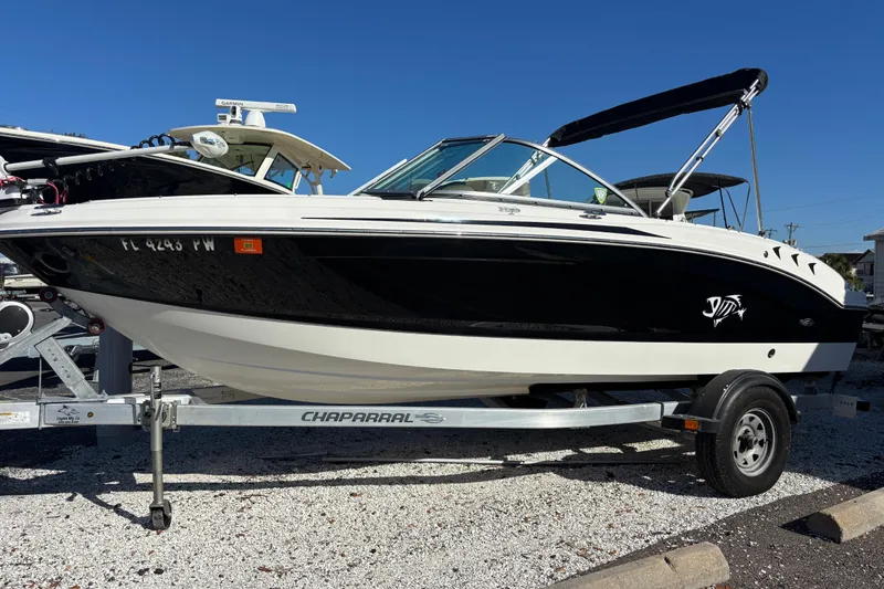 The Image of 2015 Chaparral 19 H2O Ski & Fish boat on trailer, black and white design. - 0