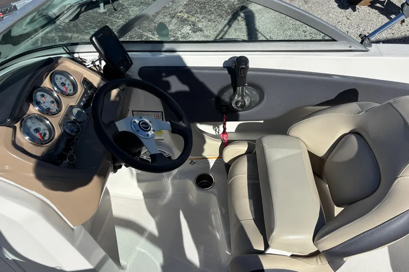 Slide: The Image of 2015 Chaparral 19 H2O Ski & Fish boat cockpit with steering wheel and gauges. - 11