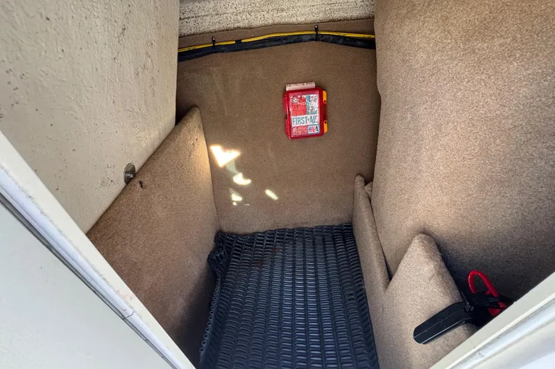 Slide: The Image of Interior storage compartment of 2015 Chaparral 19 H2O Ski & Fish boat with first aid kit. - 14