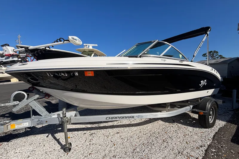 Slide: The Image of 2015 Chaparral 19 H2O Ski & Fish boat on trailer, black and white design. - 2