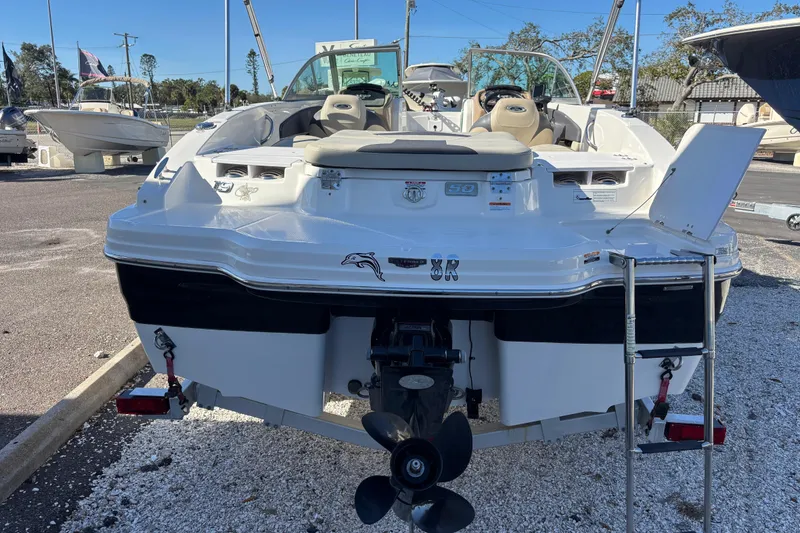 Slide: The Image of 2015 Chaparral 19 H2O Ski & Fish boat, rear view with outboard motor and ladder. - 5