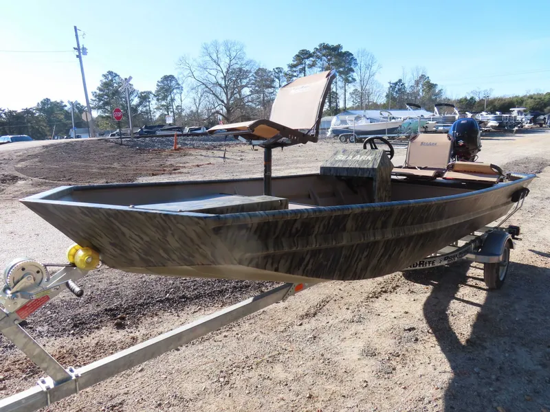 Slide: The Image of 2026 SeaArk 1648 Special Suzuki 30 on trailer, parked outdoors. - 14