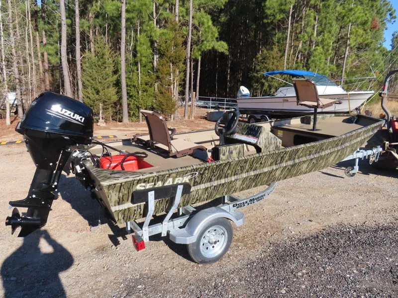 Slide: The Image of 2026 SeaArk 1648 Special Suzuki 30 Trailer parked outdoors. - 20