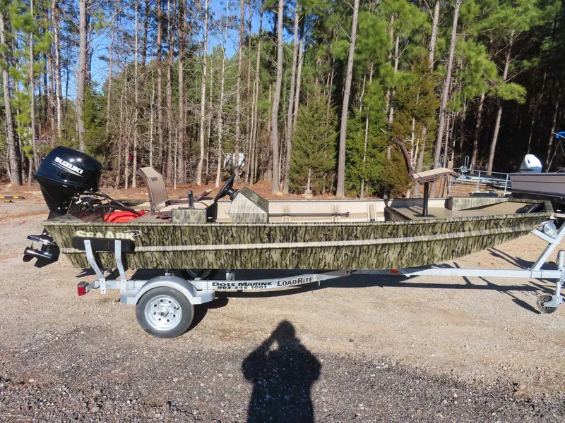 Slide: The Image of SeaArk 1648 Special Suzuki 30 Trailer boat parked in forest, 2026 model. - 21