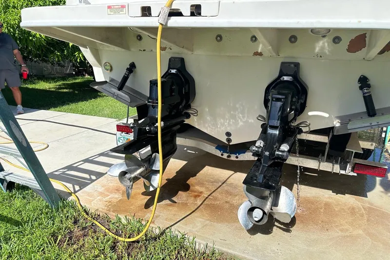 Slide: The Image of 2007 Sea Ray 270 Amberjack boat with dual propellers, parked on a driveway. - 11