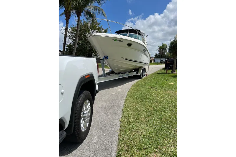 Slide: The Image of 2007 Sea Ray 270 Amberjack boat on trailer, parked on a sunny street. - 5