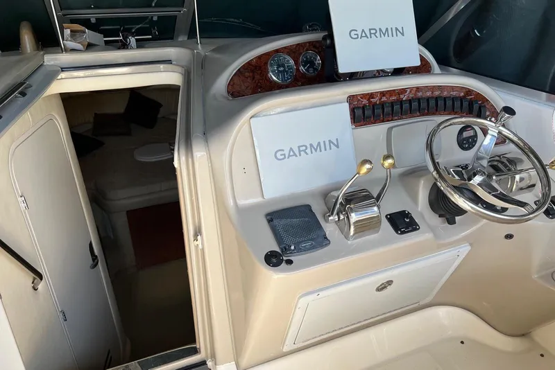 Slide: The Image of 2007 Sea Ray 270 Amberjack helm with Garmin navigation and cabin entrance. - 8