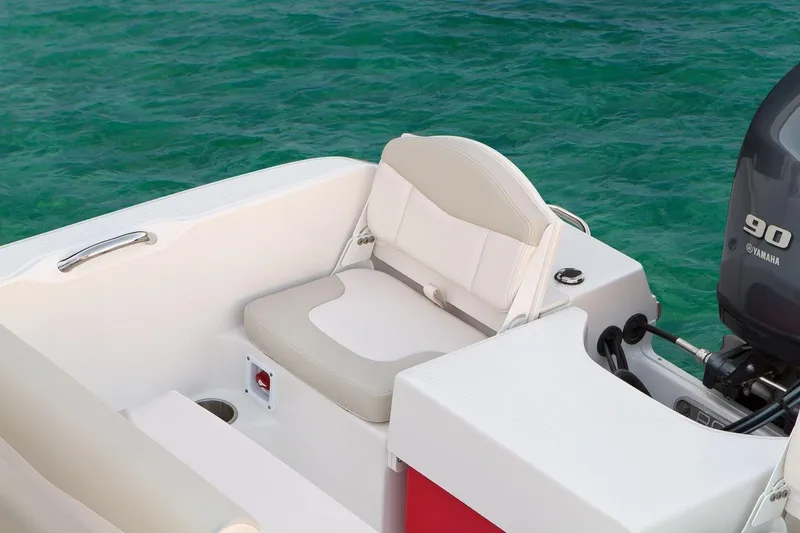 Slide: The Image of Manufacturer Provided Image: 2019 Robalo R160 Center Console boat with Yamaha 90 engine, white seating, and ocean backdrop. - 8