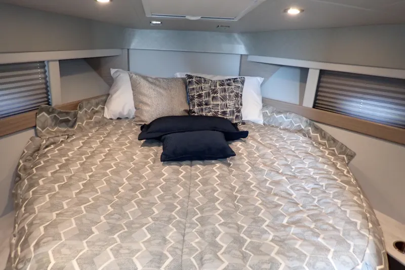 Slide: The Image of Cozy cabin interior of 2020 Formula 40 Performance Cruiser with patterned bedding and pillows. - 6