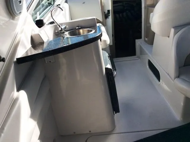 Slide: The Image of Interior of 2006 Four Winns 328 Vista with sink and seating area. - 10