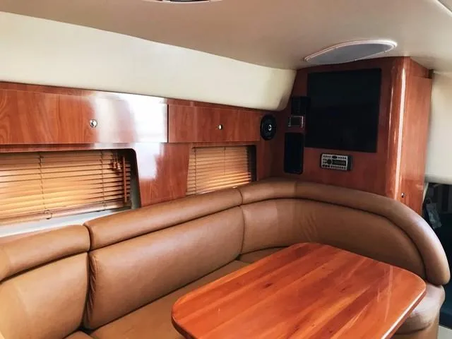 Slide: The Image of Interior of 2006 Four Winns 328 Vista with leather seating and wooden table. - 20