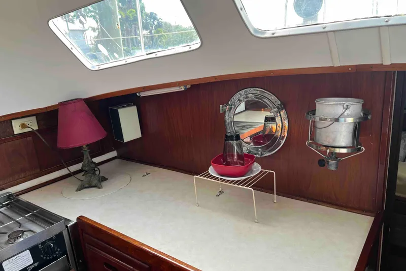 Slide: The Image of Interior of 1980 Wellington 44 Cutter Center Cockpit with lamp and nautical decor. - 21