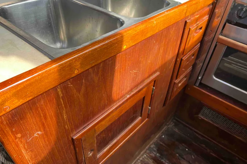 Slide: The Image of Wooden kitchen cabinetry with stainless steel sink on 1980 Wellington 44 Cutter Center Cockpit. - 23