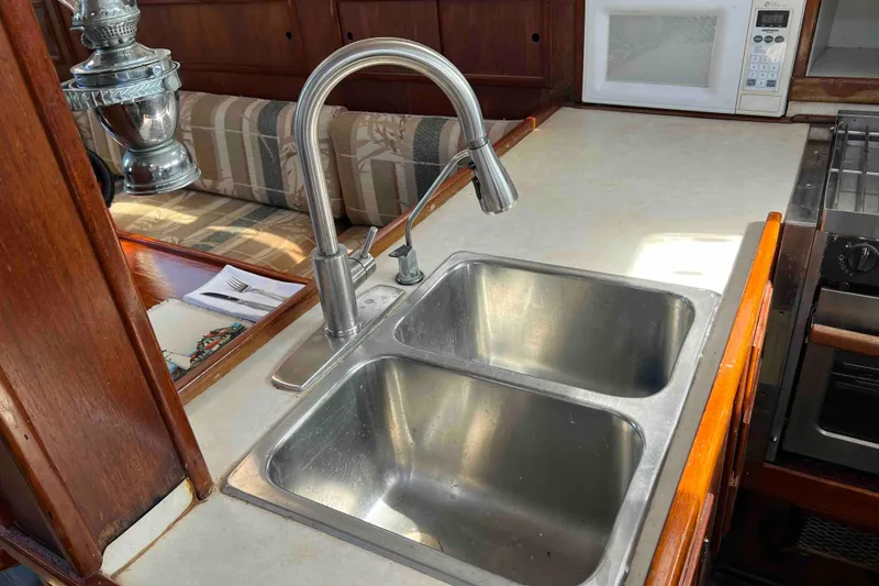 Slide: The Image of Galley kitchen in 1980 Wellington 44 Cutter Center Cockpit with double sink and microwave. - 24