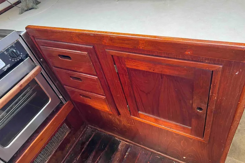 Slide: The Image of Wooden cabinetry and oven in 1980 Wellington 44 Cutter Center Cockpit yacht interior. - 27