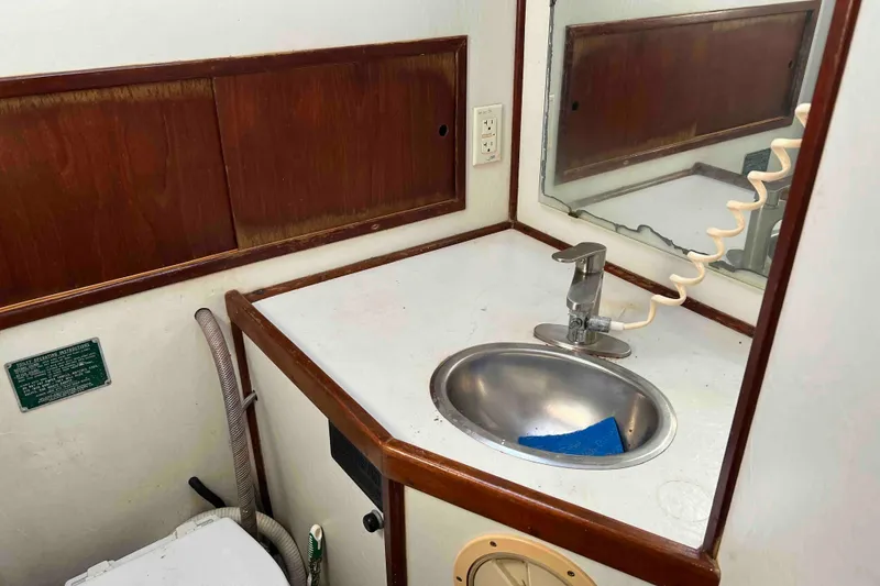 Slide: The Image of 1980 Wellington 44 Cutter Center Cockpit bathroom with sink and mirror. - 29