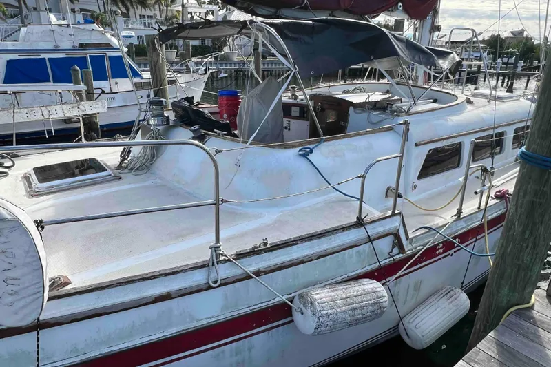Slide: The Image of 1980 Wellington 44 Cutter Center Cockpit sailboat docked at marina, featuring spacious deck. - 3