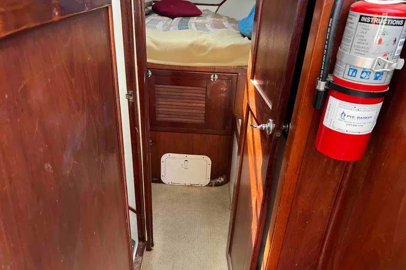Slide: The Image of Interior of 1980 Wellington 44 Cutter Center Cockpit with wooden finish and fire extinguisher. - 31