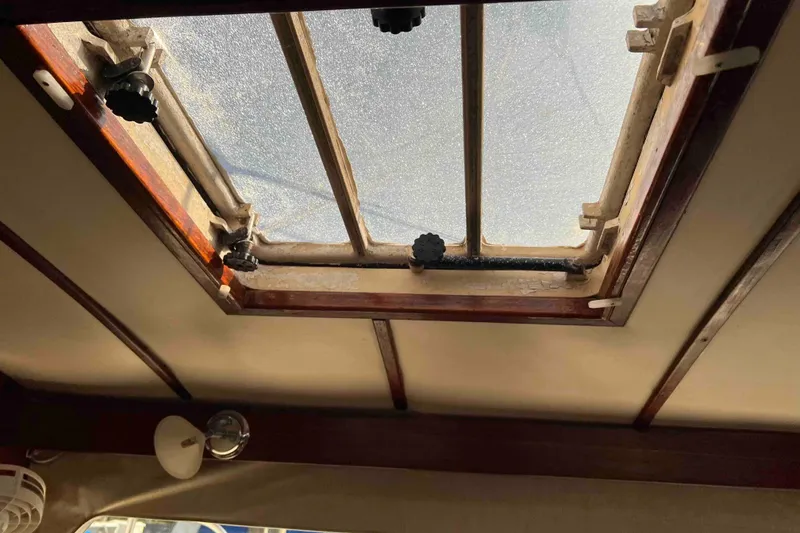 Slide: The Image of Interior view of a 1980 Wellington 44 Cutter Center Cockpit hatch with wooden trim. - 34