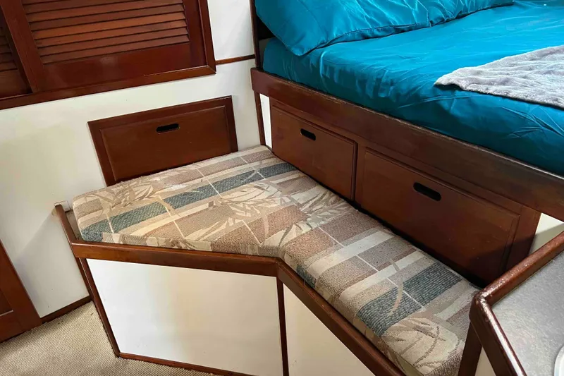 Slide: The Image of Interior of 1980 Wellington 44 Cutter Center Cockpit with cushioned bench and storage drawers. - 37