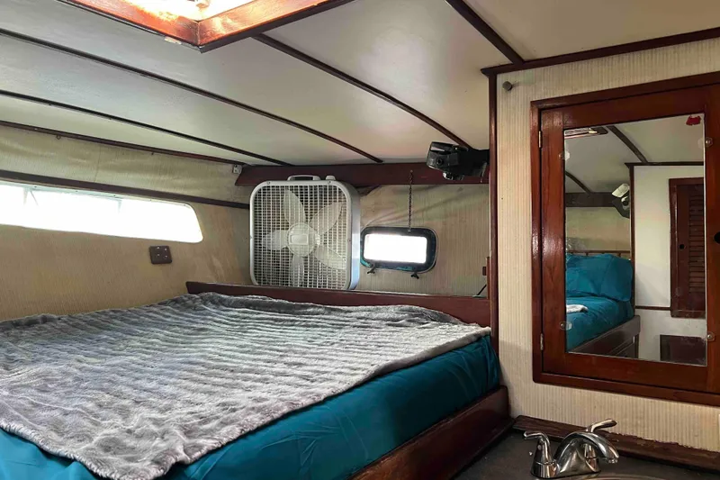 Slide: The Image of Cozy cabin interior of 1980 Wellington 44 Cutter Center Cockpit with bed and fan. - 40