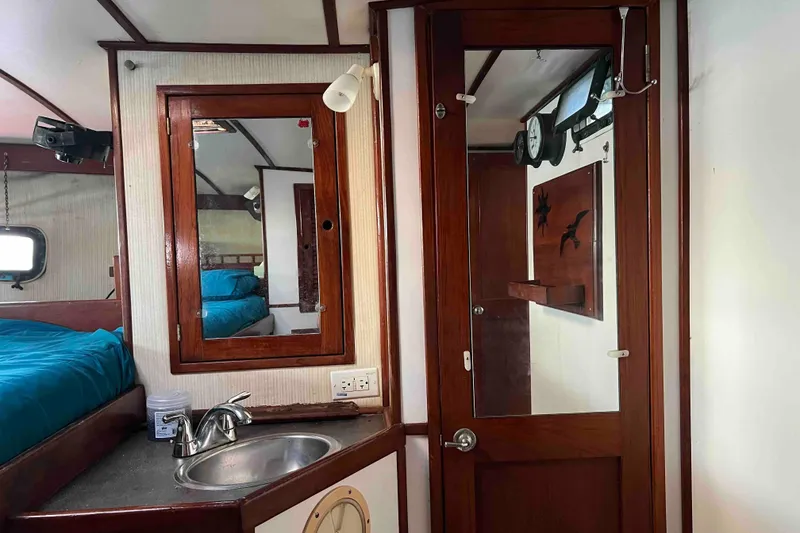 Slide: The Image of Interior of 1980 Wellington 44 Cutter Center Cockpit with wood accents and compact sink. - 41