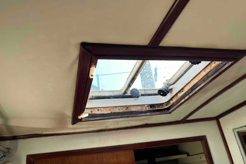 Slide: The Image of Interior view of 1980 Wellington 44 Cutter Center Cockpit, featuring a skylight hatch. - 45