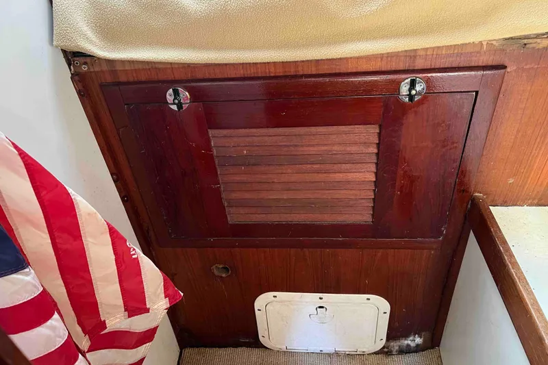 Slide: The Image of Wooden interior of 1980 Wellington 44 Cutter Center Cockpit with American flag detail. - 49