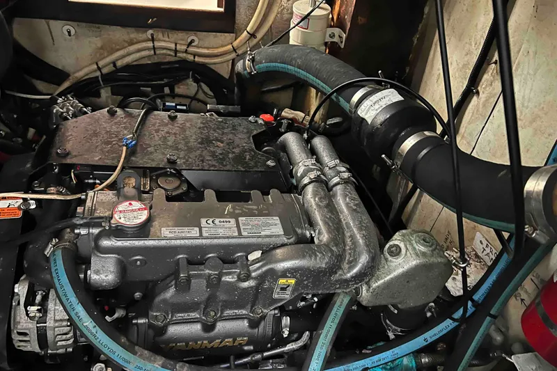Slide: The Image of Engine compartment of a 1980 Wellington 44 Cutter Center Cockpit sailboat, featuring Yanmar engine. - 53
