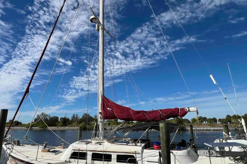 Slide: The Image of 1980 Wellington 44 Cutter Center Cockpit sailboat docked under a clear blue sky. - 6