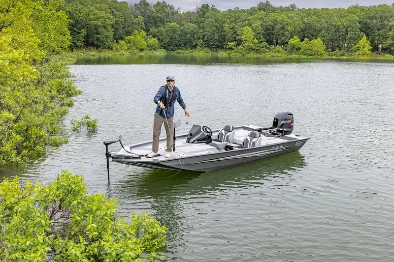 Slide: The Image of 2026 G3 Sportsman 1710 SE fishing boat on a serene lake with lush greenery. - 8