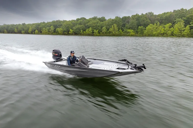 Slide: The Image of 2026 G3 Sportsman 1710 SE boat speeding on a lake with lush green forest backdrop. - 9