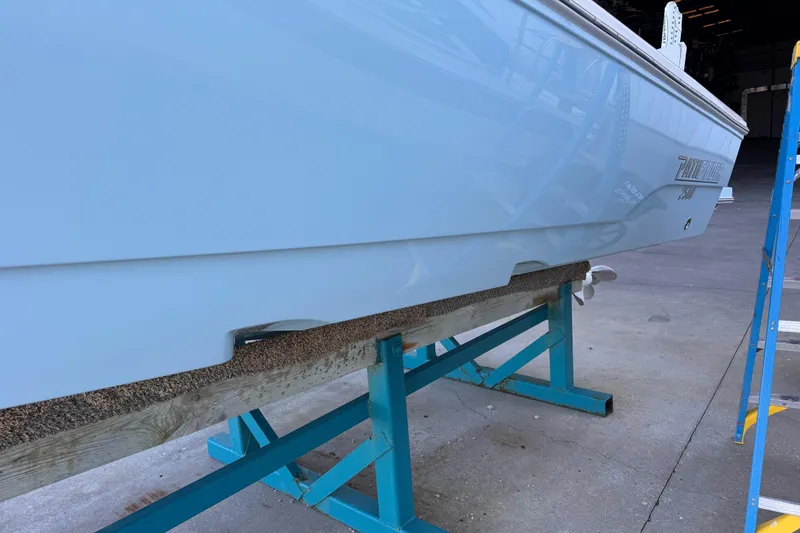 Slide: The Image of 2024 Pathfinder 2500 Hybrid boat hull on a support stand in a workshop. - 10
