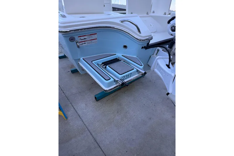 Slide: The Image of 2024 Pathfinder 2500 Hybrid boat stern with swim platform and ladder. - 12