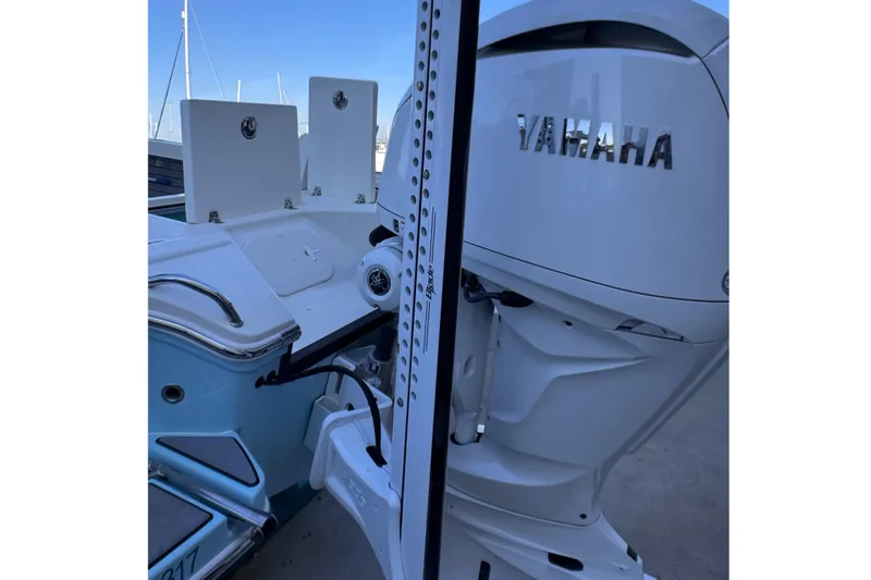 Slide: The Image of 2024 Pathfinder 2500 Hybrid boat with Yamaha outboard motor, docked at marina. - 14