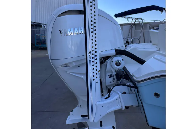 Slide: The Image of 2024 Pathfinder 2500 Hybrid boat with Yamaha outboard motor, docked in a marina. - 15
