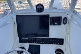 Slide: The Image of 2024 Pathfinder 2500 Hybrid boat dashboard with Garmin display and JL Audio system. - 6