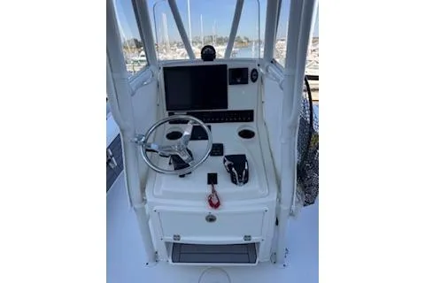 Slide: The Image of 2024 Pathfinder 2500 Hybrid boat with Garmin equipment at a marina dock. - 7