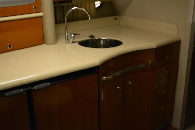 Slide: The Image of 2006 Formula 40 Performance Cruiser interior with carpeted floor and wooden cabinet. - 27