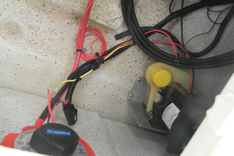 Slide: The Image of 2024 Carolina Skiff e-18 boat wiring and pump system close-up. - 5