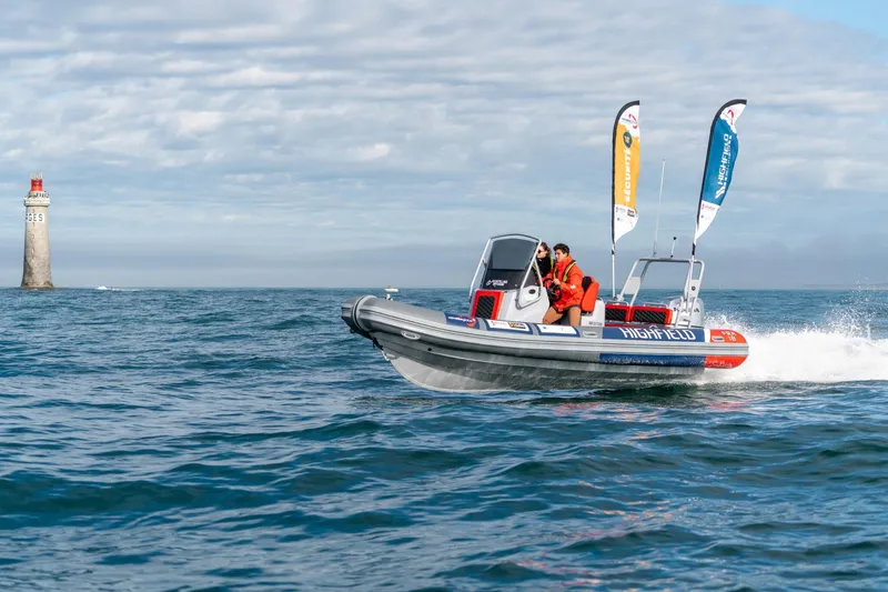 Slide: The Image of Highfield Patrol 660 boat 2026 on the sea with lighthouse in background. - 2