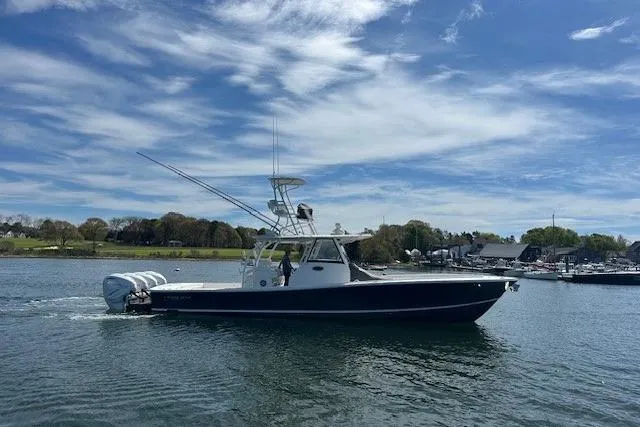 Slide: The Image of 2022 Regulator 41 boat on calm water under a partly cloudy sky. - 1