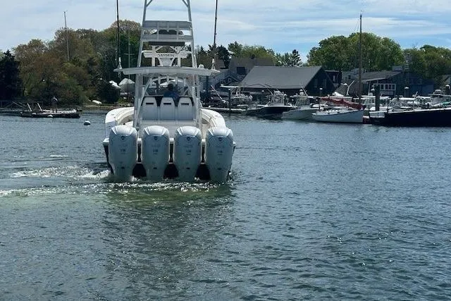 Slide: The Image of 2022 Regulator 41 boat with four engines cruising in a marina. - 10