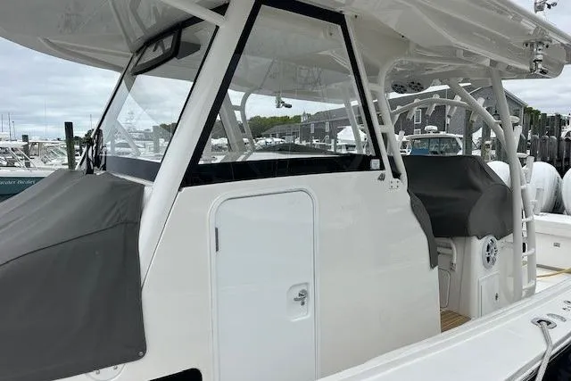 Slide: The Image of 2022 Regulator 41 boat with sleek design, featuring a covered helm and modern amenities. - 16