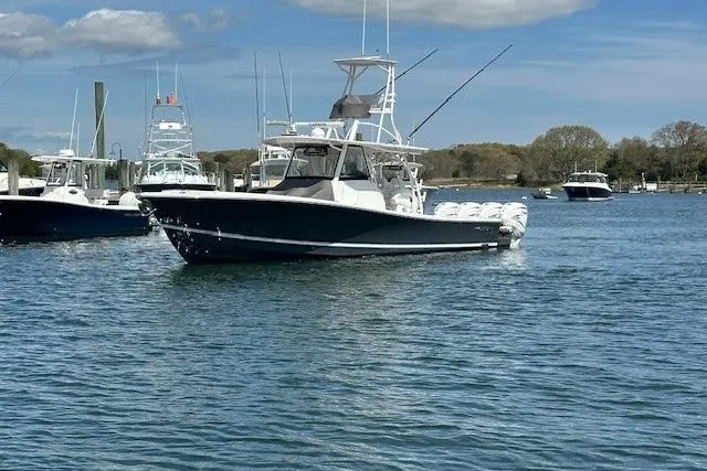 Slide: The Image of 2022 Regulator 41 boat on calm water with clear sky background. - 2