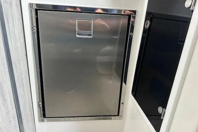 Slide: The Image of Stainless steel refrigerator in 2022 Regulator 41 boat interior. - 20